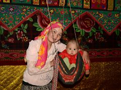 08 Yilik Headman Daughter And Her Child In A Swing In Their Sleeping Area On The Way To K2 China Trek.jpg